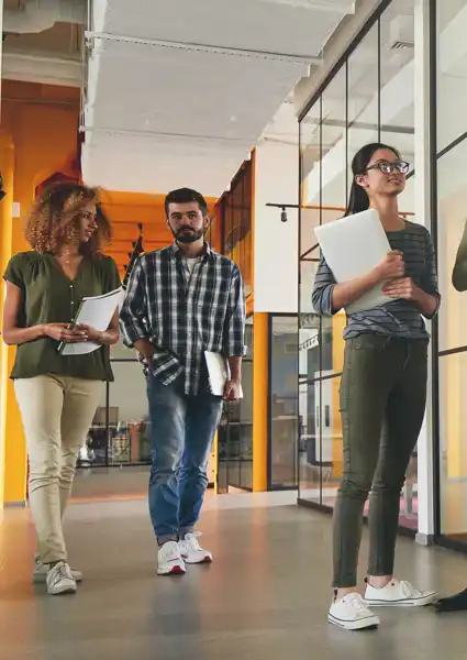 A group of people discussing in the hallway