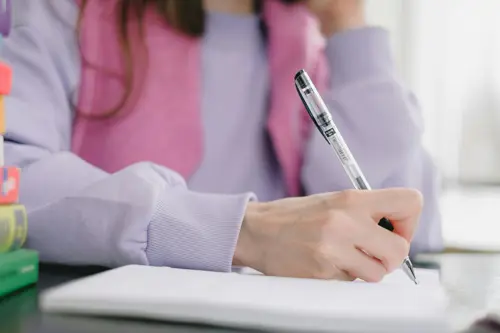 student writing in a notebook