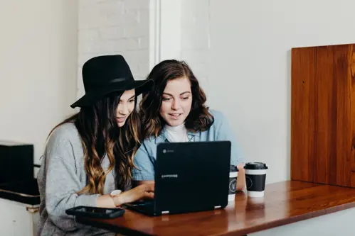 Two girls working on a laptop