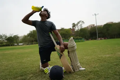 Cricketer drinks a sport drink
