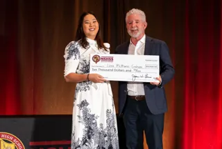 Jim and a woman holding a $10,000 check