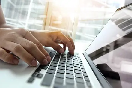 Person typing on a keyboard