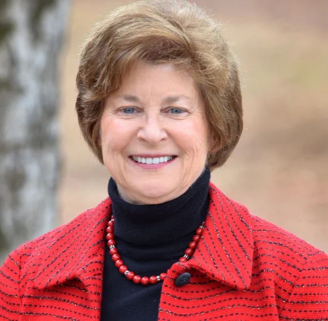 An older woman named Nancy Beane with blond hair smiling