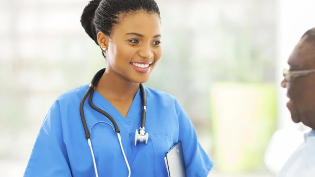 Black woman doctor interviewing patient