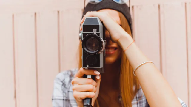Girlholdingcameratakingpicture_2023