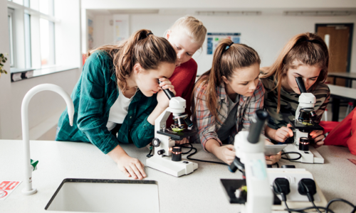 High School students using a microscope at a science class